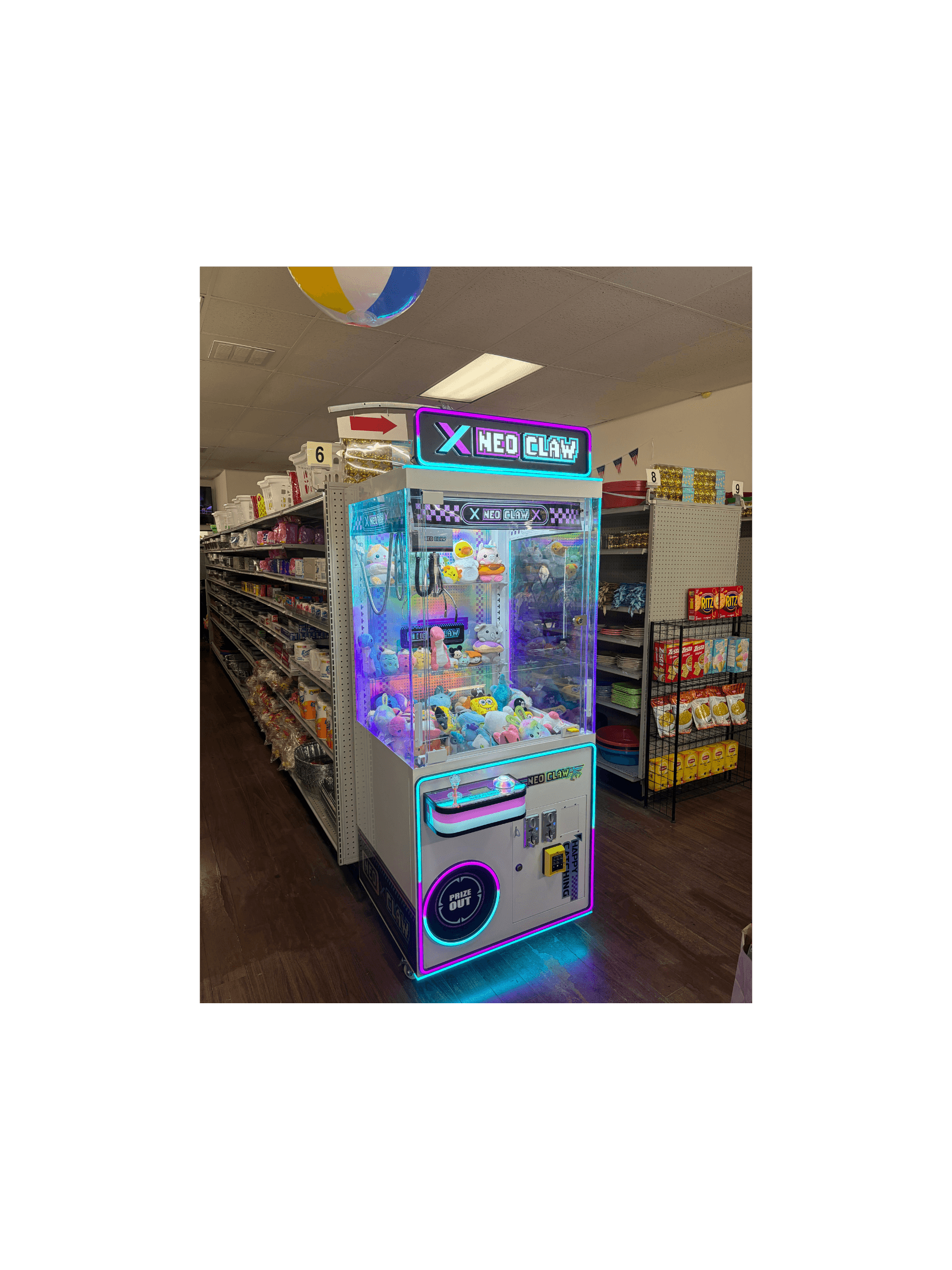 Brightly lit Neo Claw machine filled with stuffed animals in a grocery store aisle.